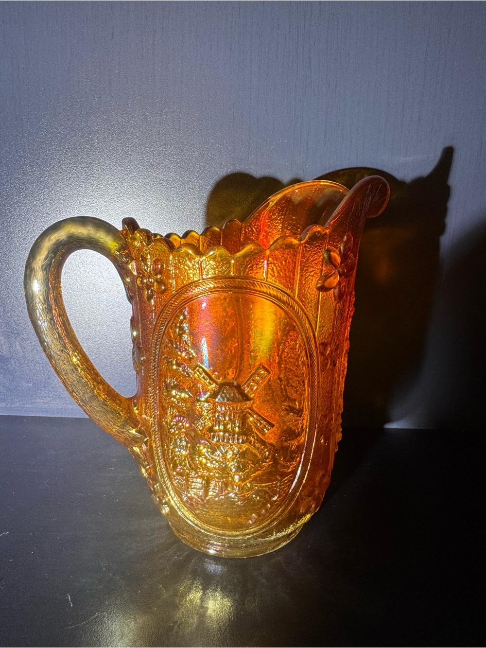 Iridescent Orange Glass Pitcher with Windmill Motif
